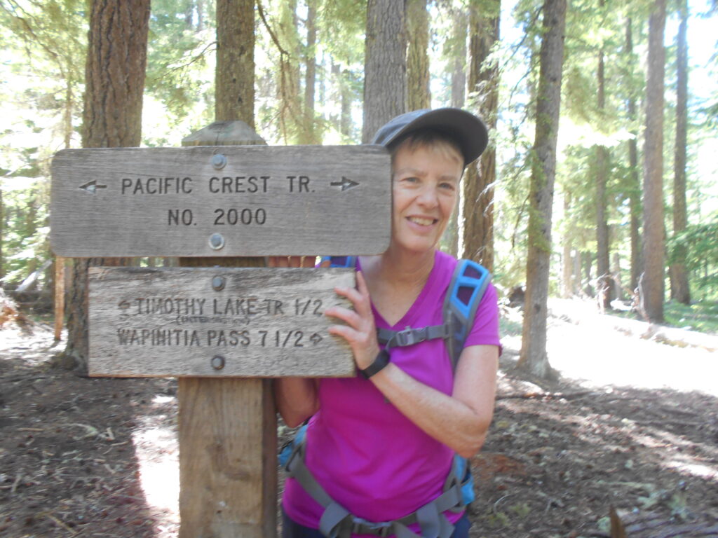woman wearing a hat on a hiking trail